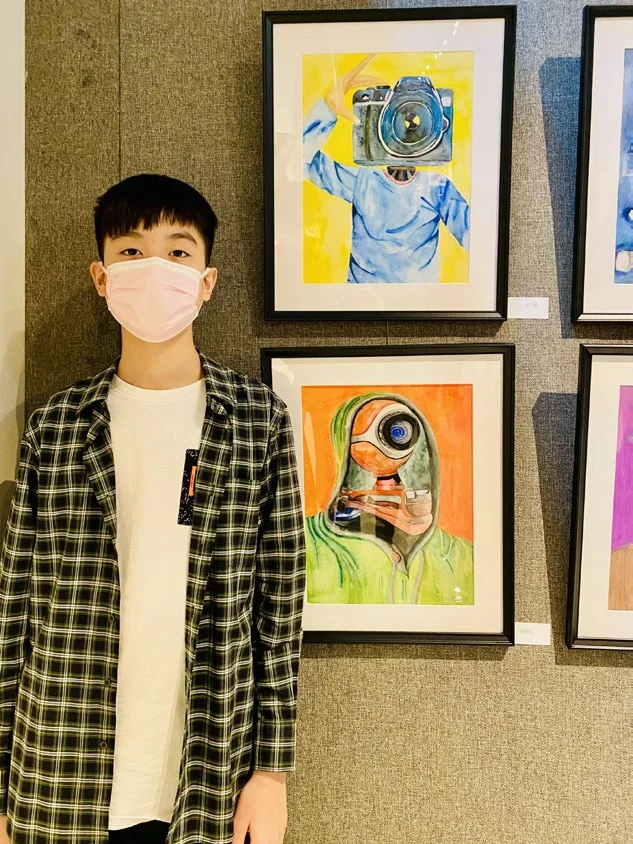 Portrait beside The Cameraman and another painting